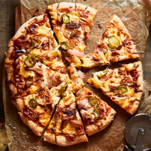 BBQ chicken pizza topped with grilled chicken, red onions, and fresh cilantro.