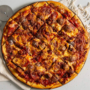 Meat lovers pizza topped with pepperoni, sausage, bacon, and ham.